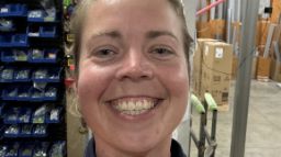 Emma Reece takes a selfie in a warehouse