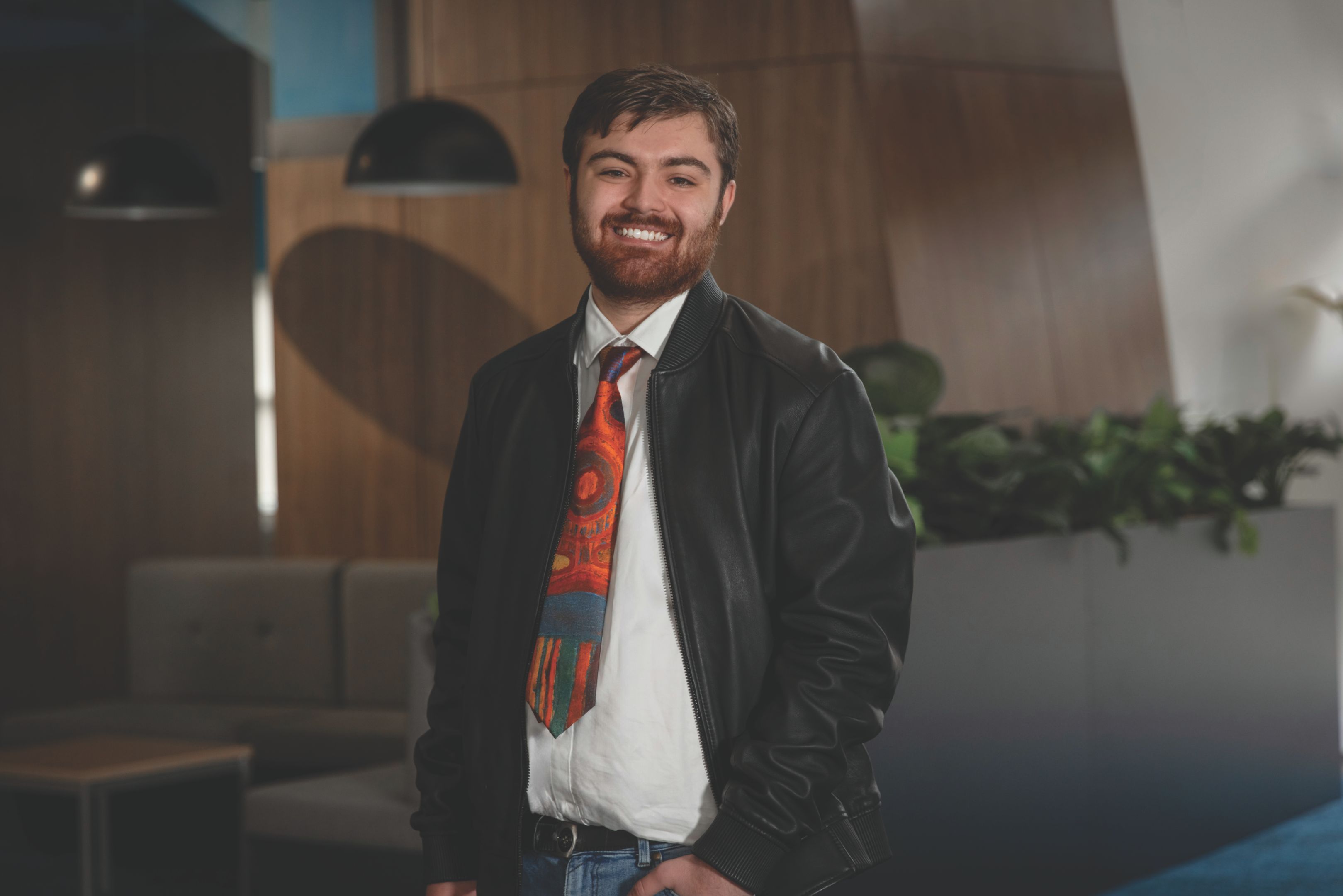 Person standing front on smiling at camera.
