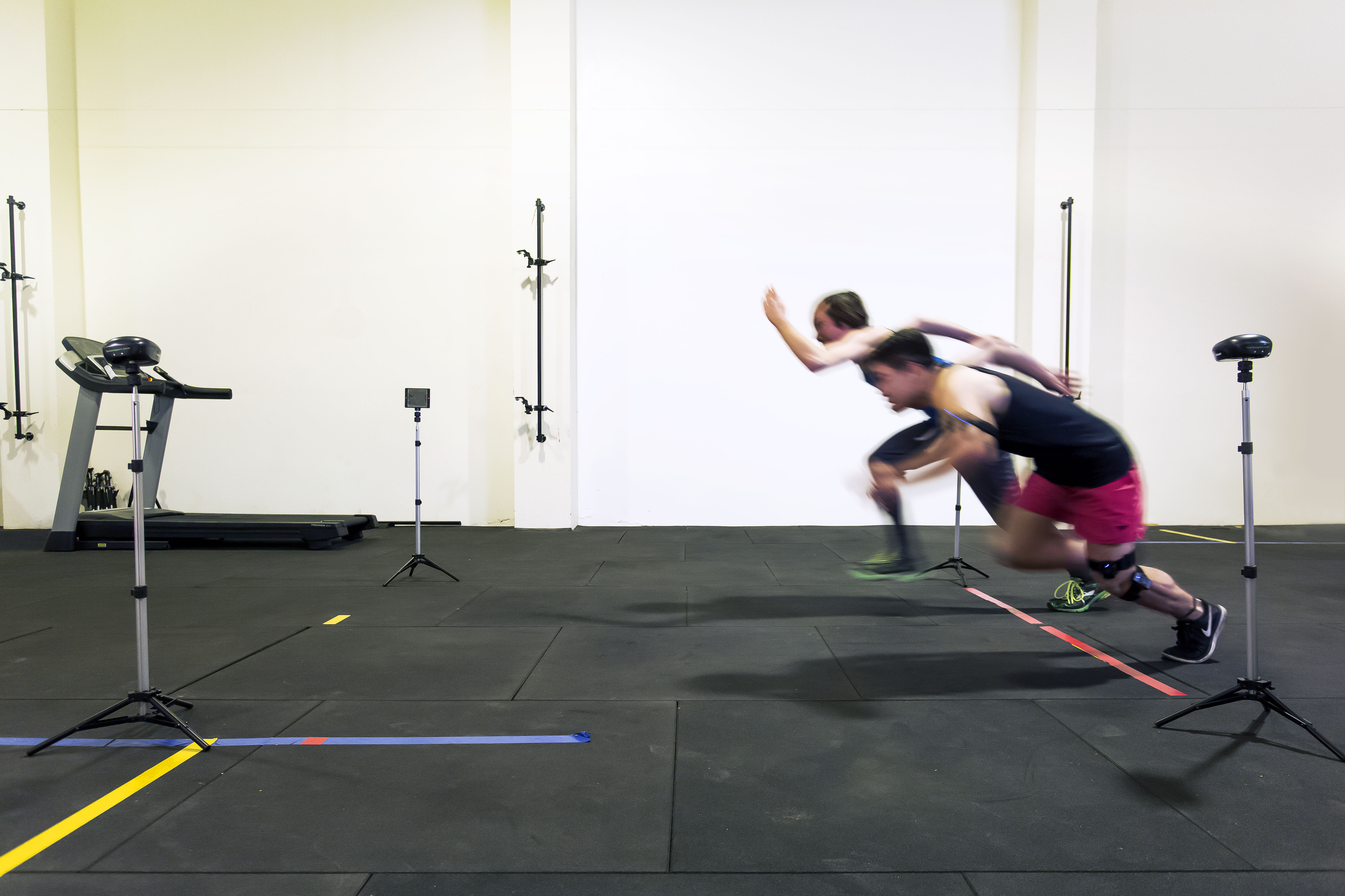 Two people testing running ability in a controlled clinical environment. 