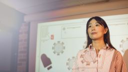 A female TAFE business student presenting her work in a classroom