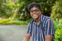 Swinburne student Minura sits in the green surrounds of Hawthorn’s Central Gardens 