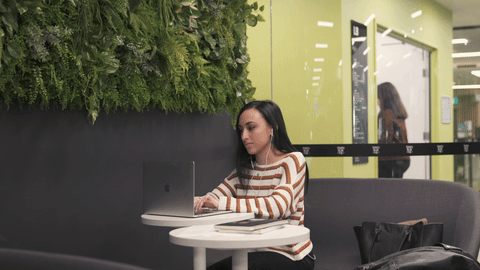Young woman studies at desk. Song comes on. Crazy dancing. Sits again at desk and resumes studying. 10-15 sec.