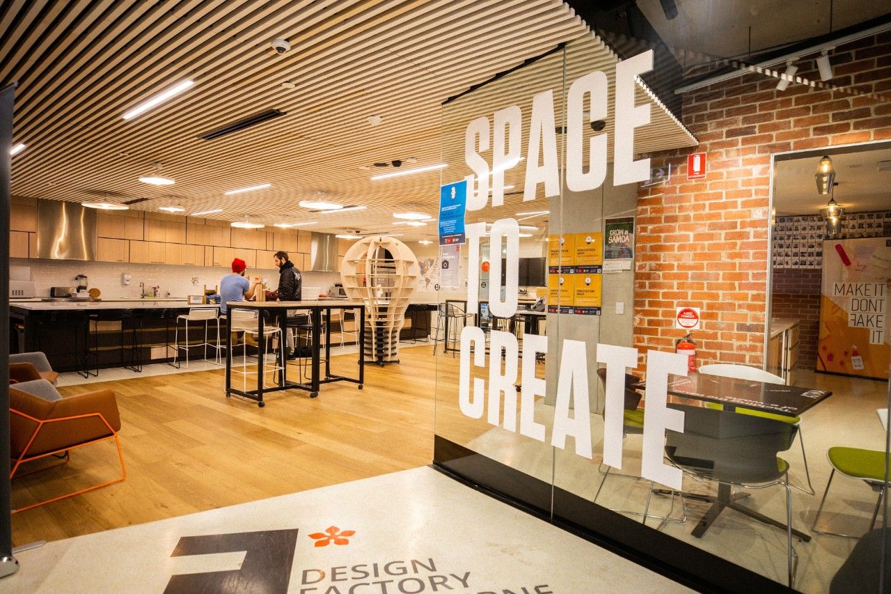 Swinburne’s Innovation Studio, with glass panels in the foreground with ‘Space to Create’ printed in bold letters.