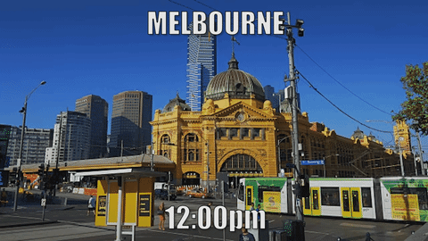 A tram runs past Flinders street in sunny weather, half an hour later it’s raining.