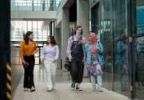 Four students walking down a corridor in Swinburne’s Advanced Technologies Centre. 