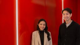 Two international students in TD building smiling at the camera