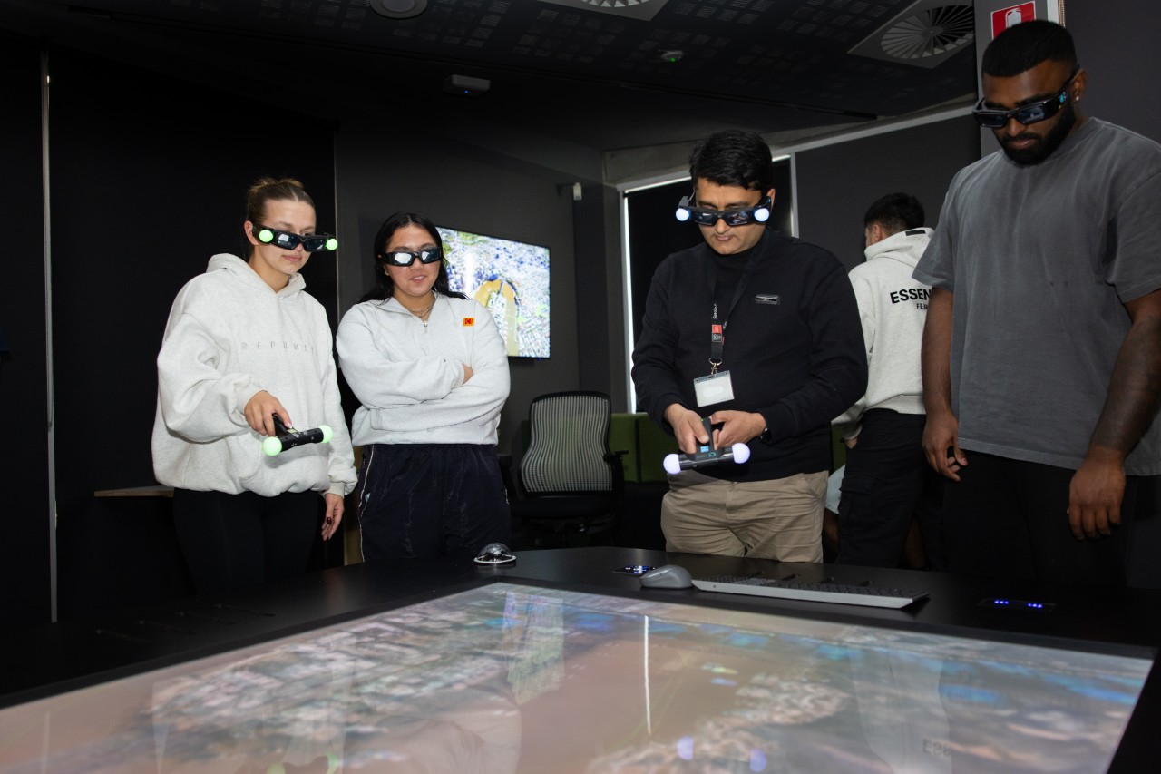 Students collaborating using the Axiom Holographic Table to review and explore 3D designs for construction planning and asset management.  