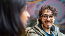 International student Jordan having a conversation with another student in a cafe on Hawthorn campus