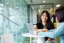 International student Huong Nhi faces the camera, smiling.