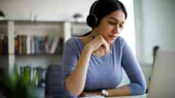 Young woman with headphones working from home