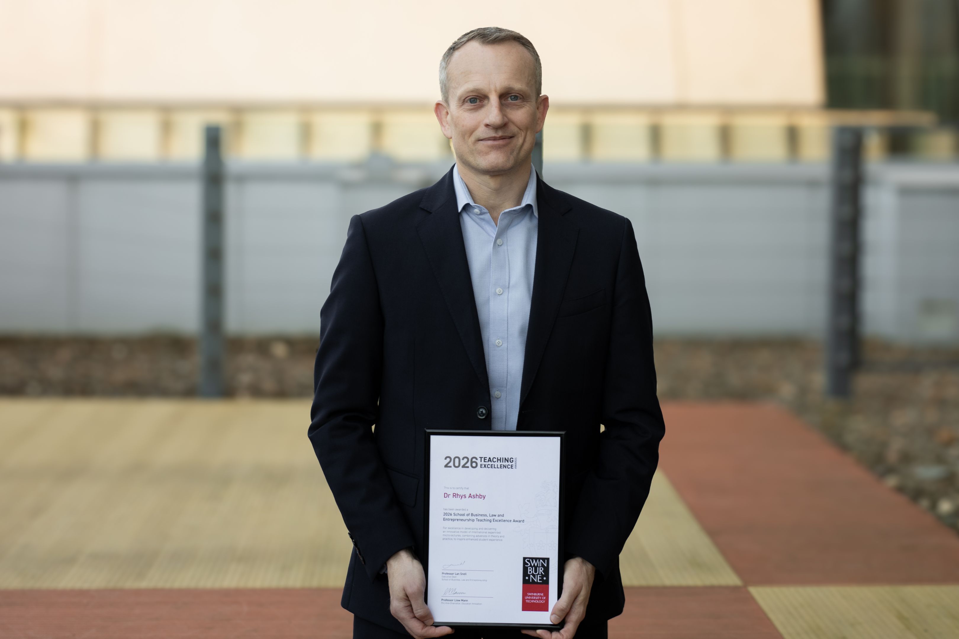 2026 School Teaching Excellence Award recipient Dr Rhys Ashby with his certificate