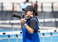 Swinburne design alum Joanna Margiolis taking photos at her local athletics club
