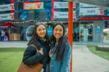 two female students hug and smile to camera at the Hawthorn campus
