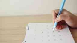 A person marking a calendar