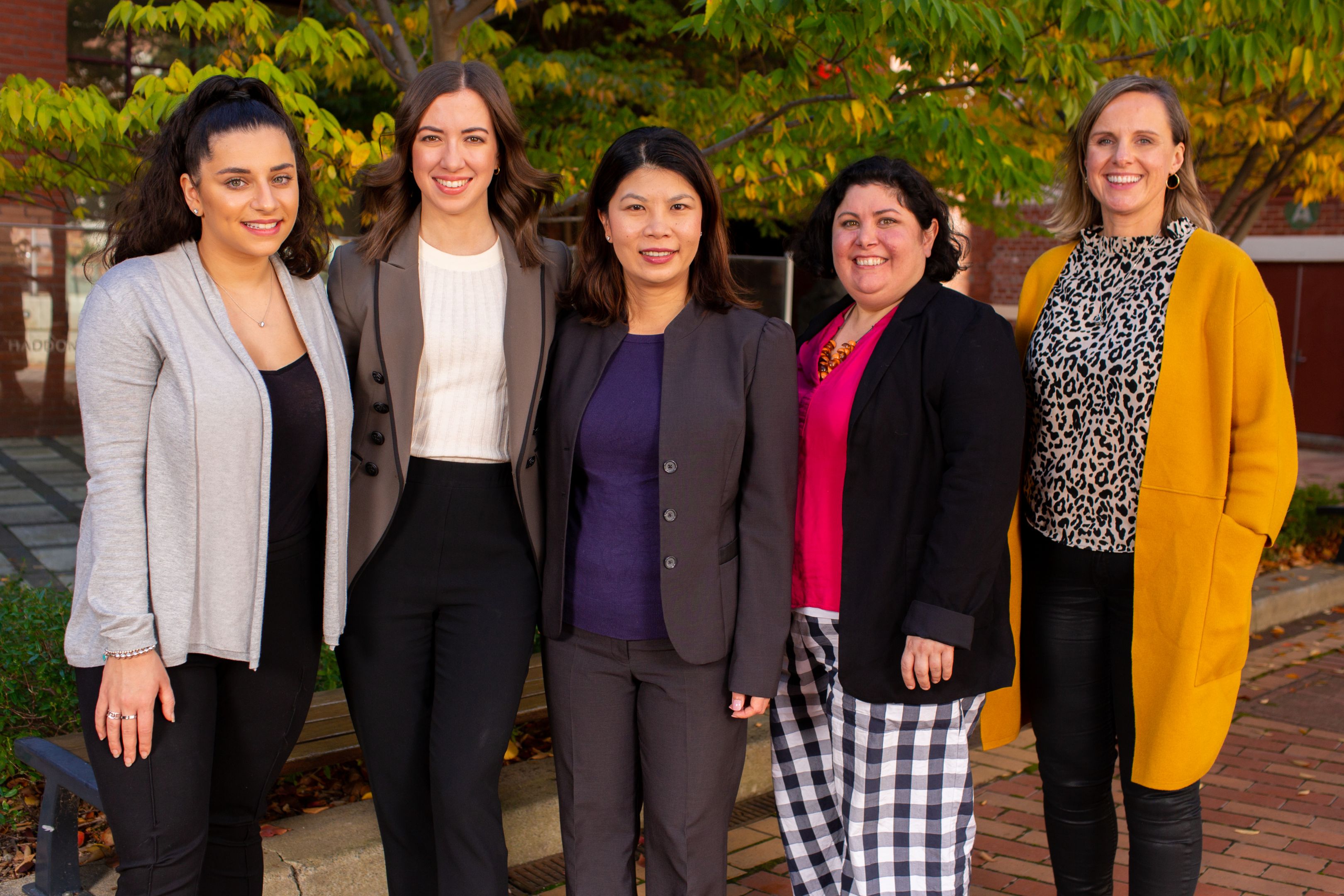 Five ladies in business attire from Avanade and Swinburne standing side by side