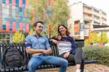 Two students sit on a bench outside the Moondani Toombadool Centre