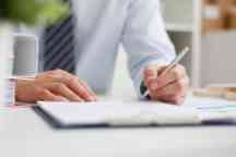 Male hand holding silver pen ready to