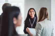 Group of people talking at a professional development event.