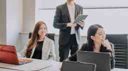 Corporate professionals attending a business meeting.