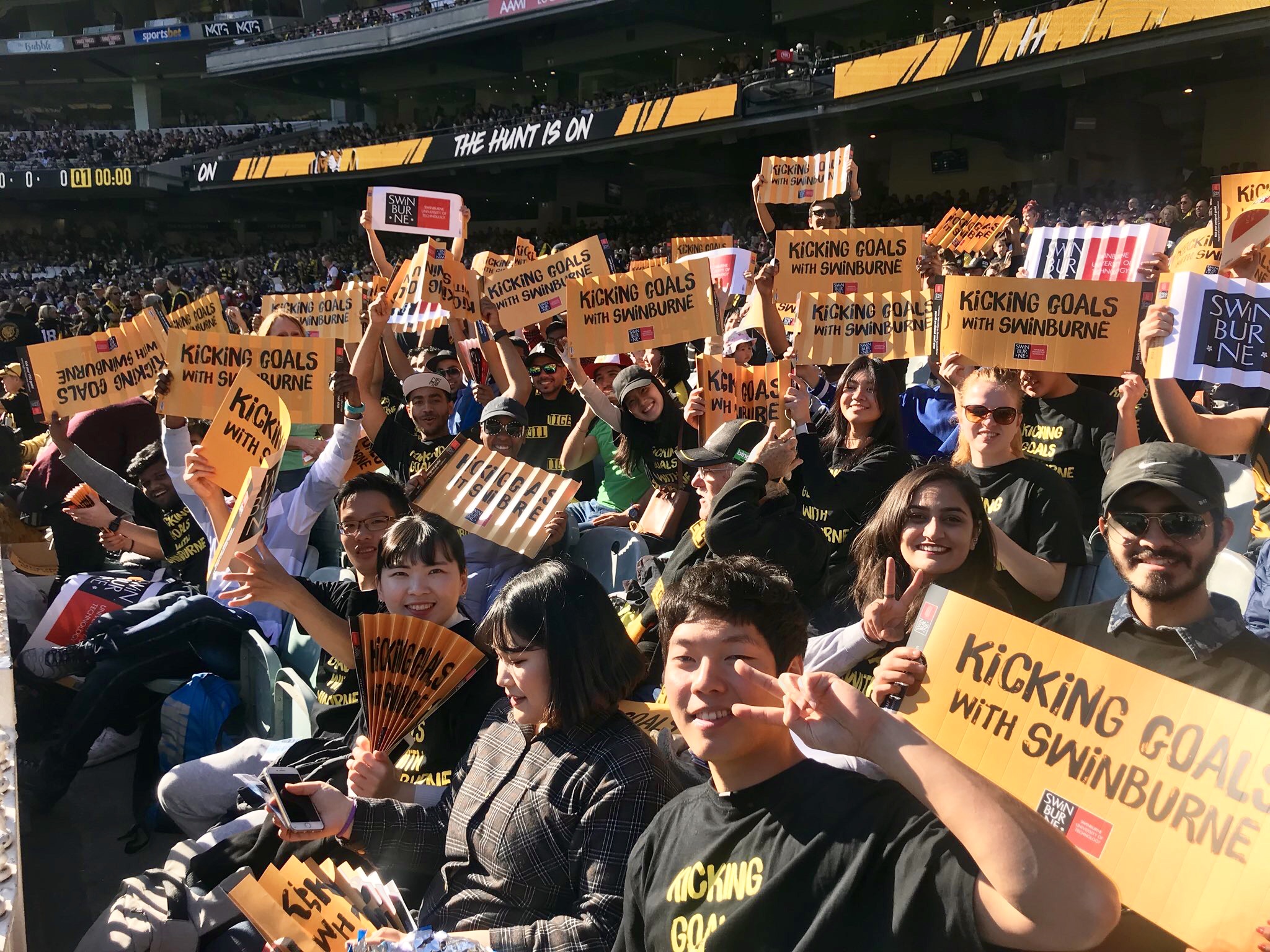 Swinburne students socialising watching the AFL at the MCG