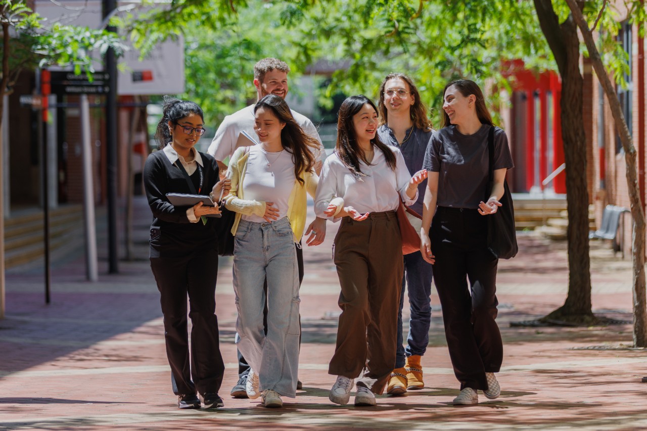 A group of students walking and laughing together at Swinburne, Hawthorn campus