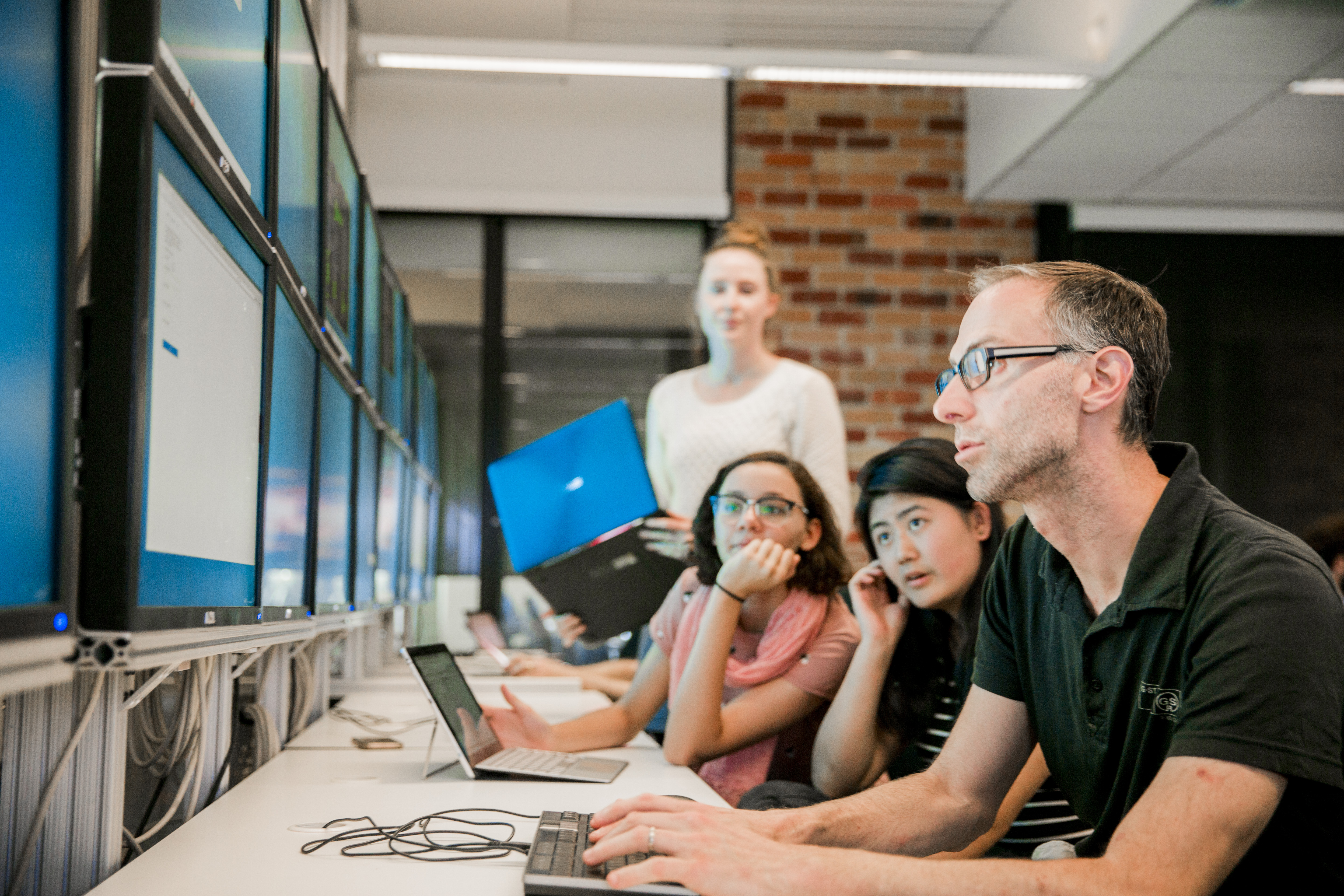 People gathered around a computer 