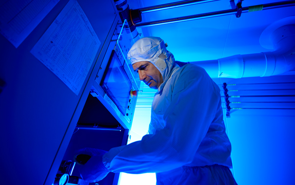 Saulius Juodkazis is leaning over doing some research in a lab
