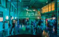 A modern open event space with a large globe like area.