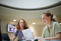 Two students sitting together studying in AMDC level 6 