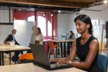 south asian postgraduate student working on computer modern space