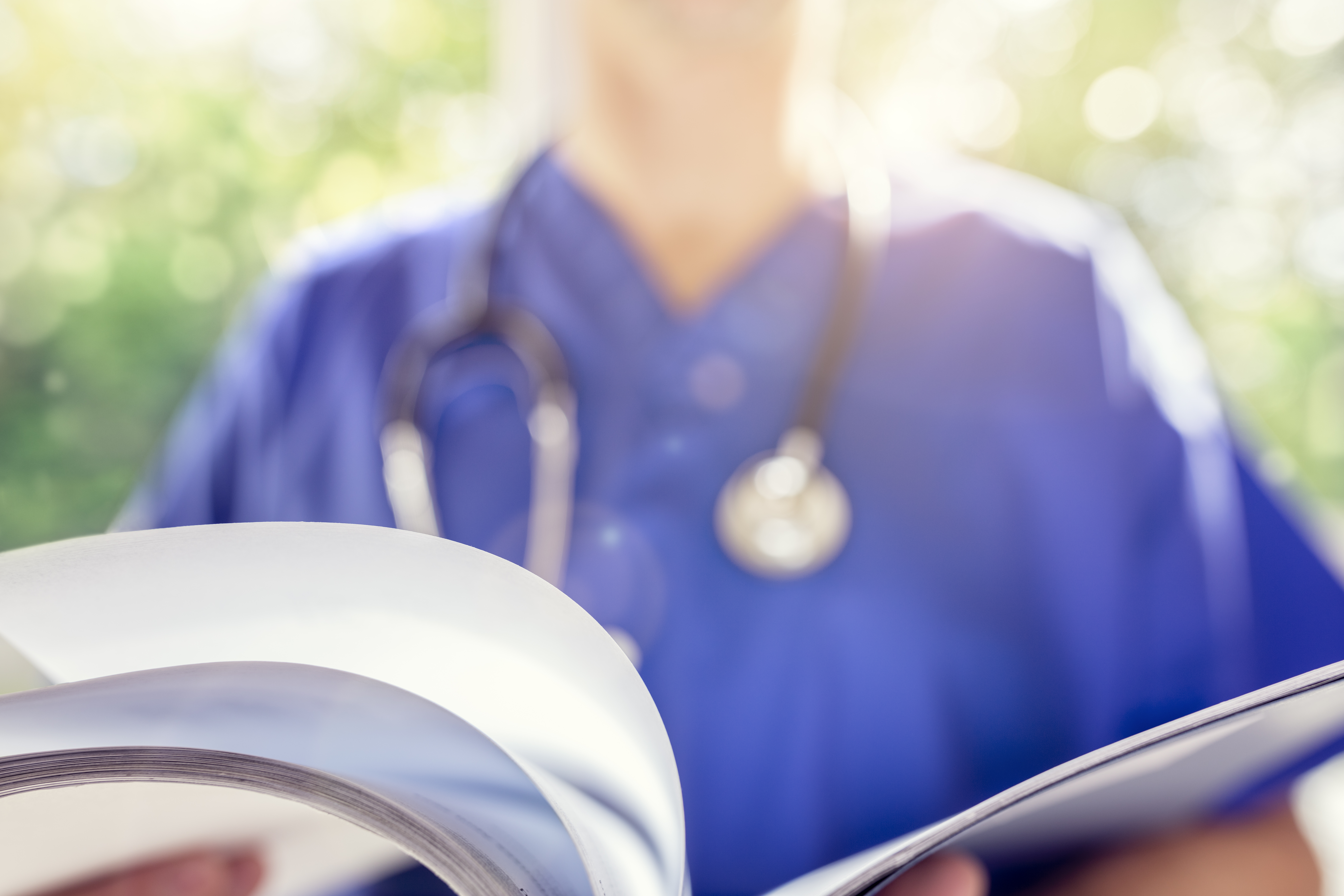 Nurse reading patient notes or medical chart