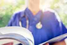 Nurse reading patient notes or medical chart