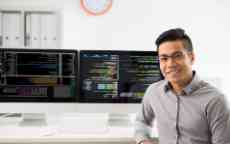 Young programmer smiling at the camera.