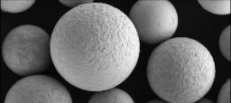 Large monochromatic spheres, several times larger than a 20µm scale, are visible. This is a scanning electron microscope image of Swinburne and EntroMat's high entropy powder.