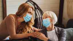 A younger woman with an elderly woman in aged care