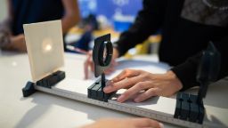 Scientists work with optics and light beam in laboratory