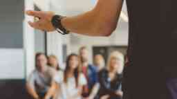 A person presenting in front of a class