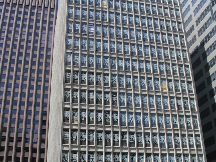 An empty office building in Melbourne with tagging on every single window.