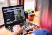 Person using a laptop, looking at a "Swinburne Edge" webpage