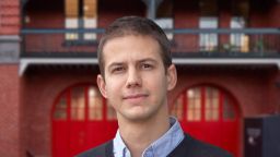 Young man in professional attire looking at the camera