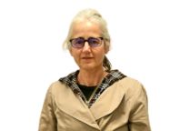 Portrait of a person wearing glasses, smiling slightly.