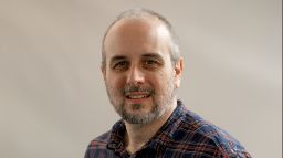 Dr Jason But headshot smiling inside 