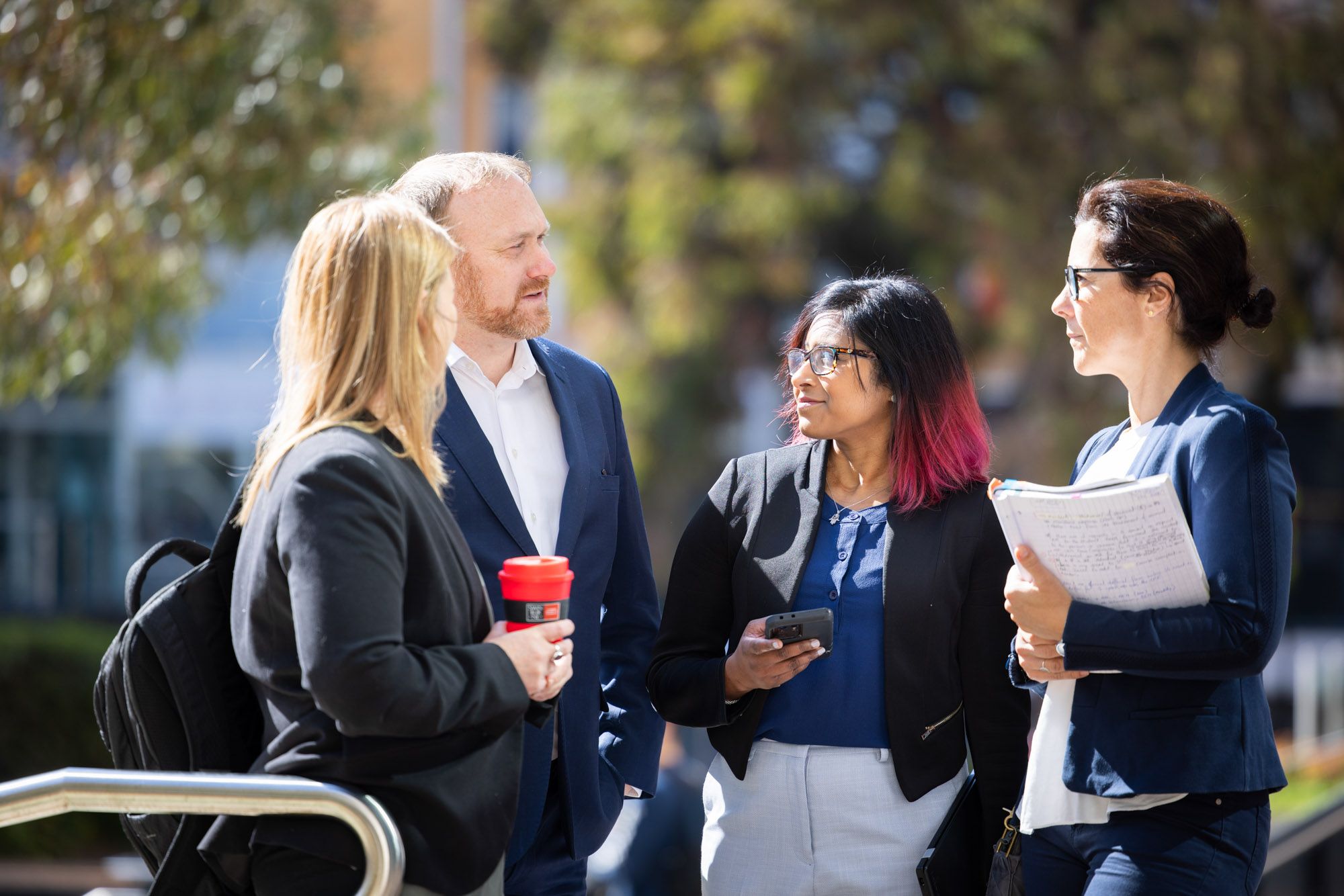 4 people having a conversation