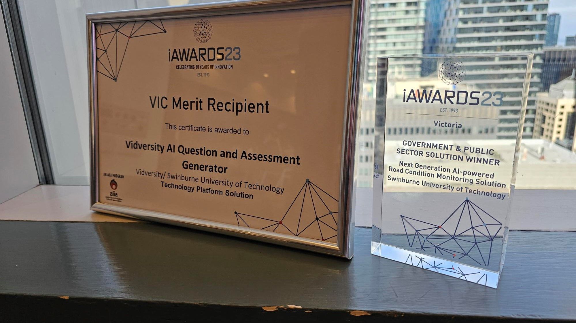 Award plaque and glass trophy.