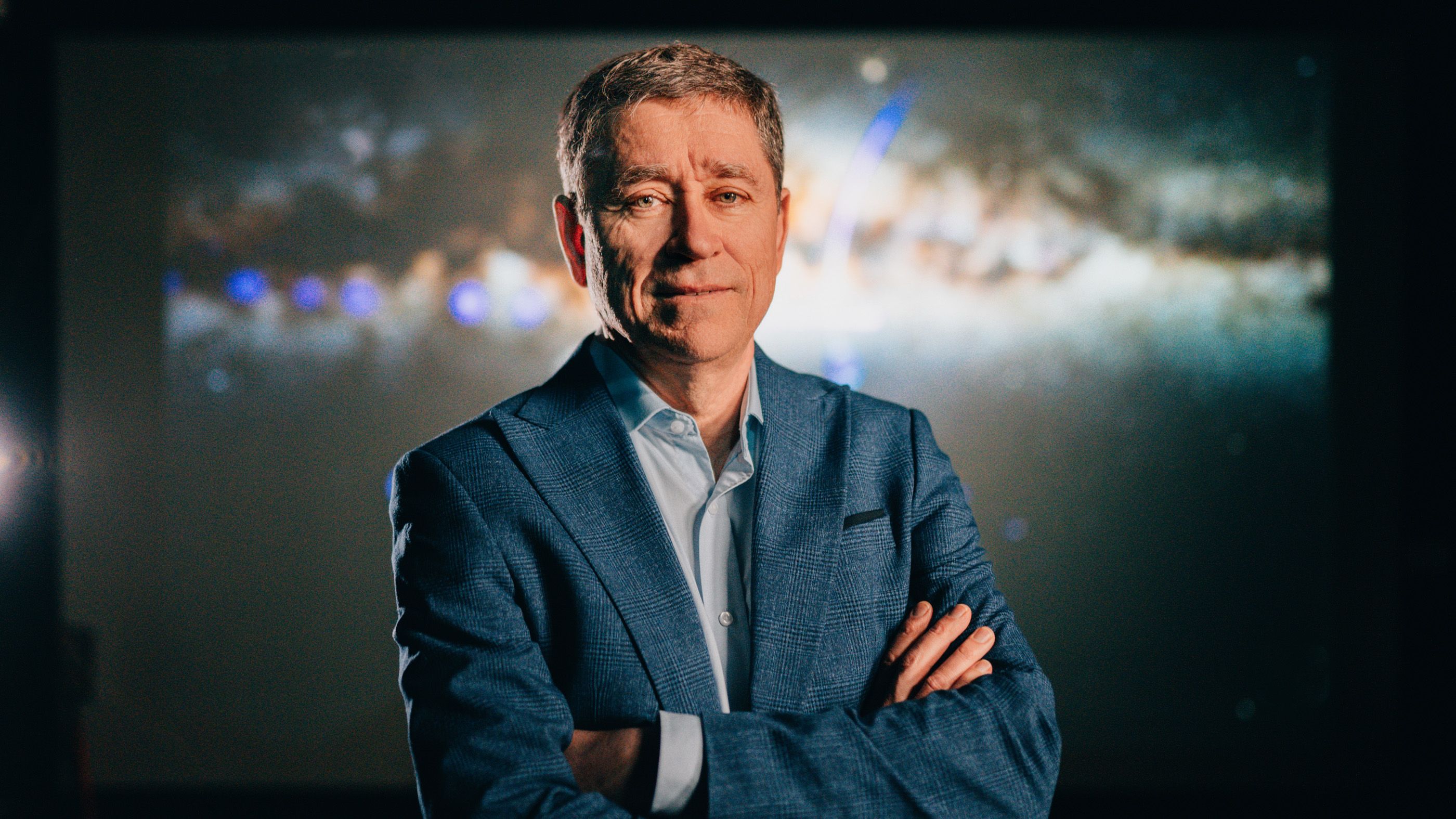 Australian Science: Man in a suit posing for the camera with his arms crossed