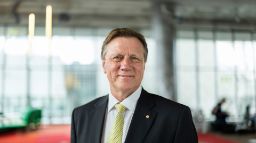 Swinburne University Chancellor, John Pollaers, smiles to camera in The George building of the Hawthorn campus