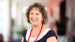 Professional looking woman facing the camera and smiling.