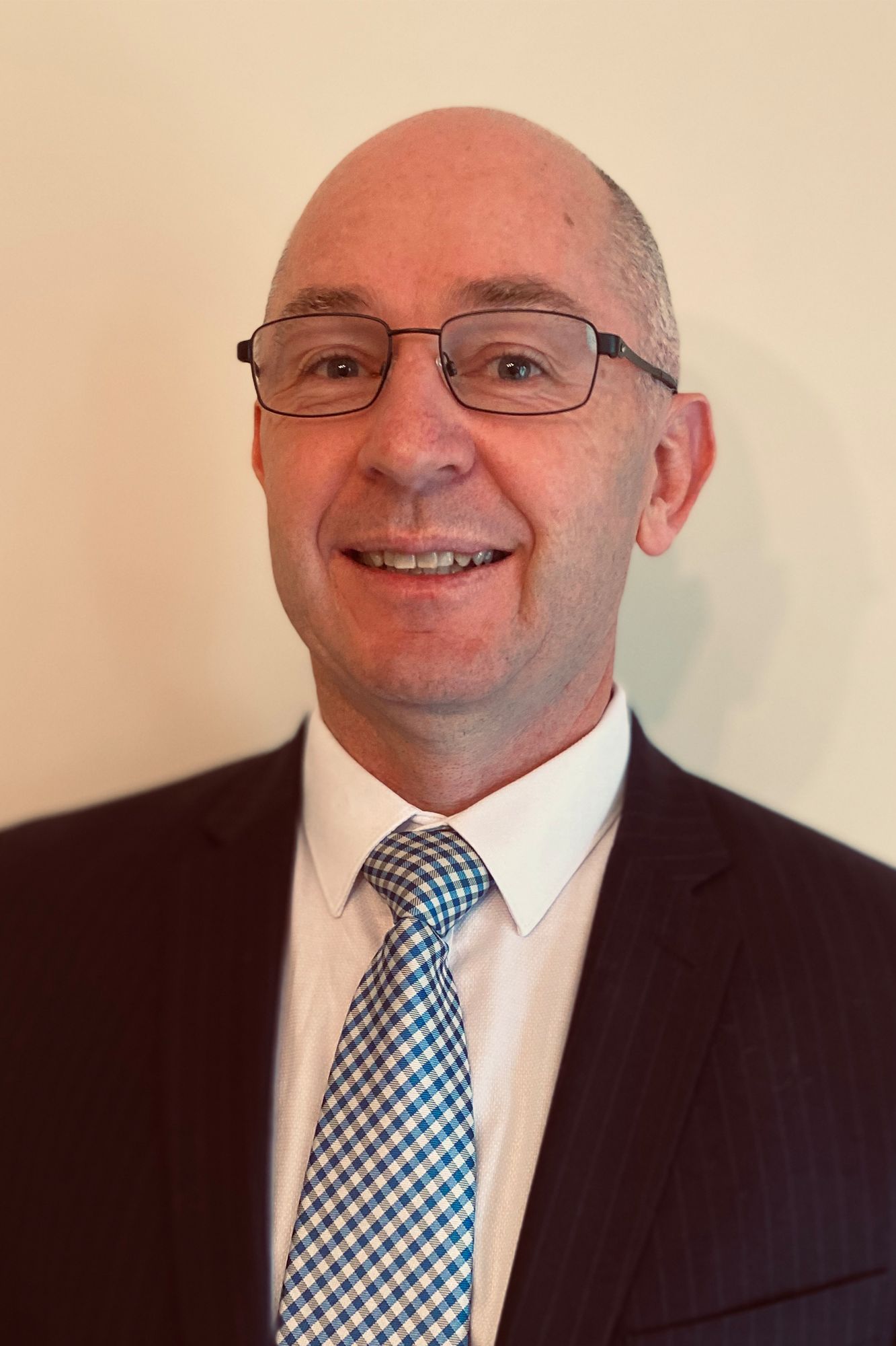 Man with glasses smiling at the camera