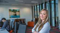Female psychophysiology student smiling to camera arms folded