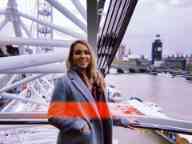 Female standing in the London Eye with London city in the background